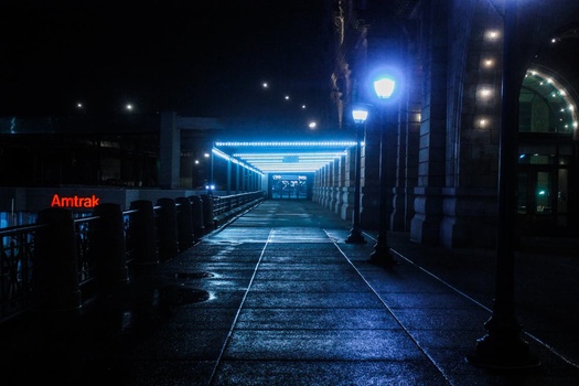 a low-key image of the entrance to an Amtrak station at night