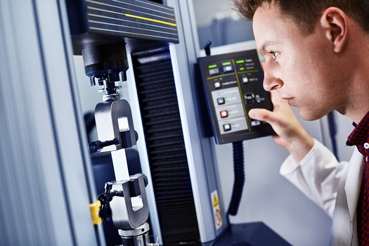Photograph of a man using an engineering machine.
