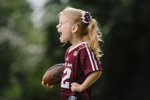 Portrait of a little girl in a football uniform