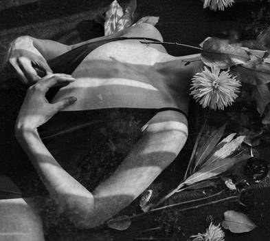 Tips and Tricks for Shooting Self Portraiture A girl's body covered with plants and flowers.