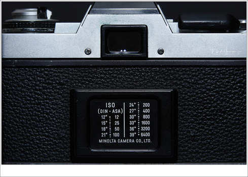 An old Minolta XG-1 with the ISO (DIN-ASA) table on the back. You had to set the film sensibility once for all the 12, 24, or 36 frames you had to your disposal.