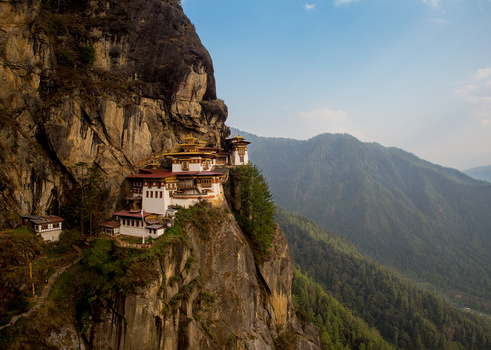 Paro Taktsang or Tiger's Nest Monastery clinging to the edge of a cliff.