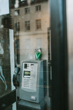 simple street photography projects for beginners An used beer can on top of a pay phone