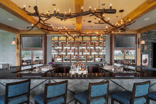 hotel bar with high stool seating and oak-wood timber beams above