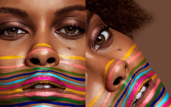 Beauty photo of model with color lines drawn on face
