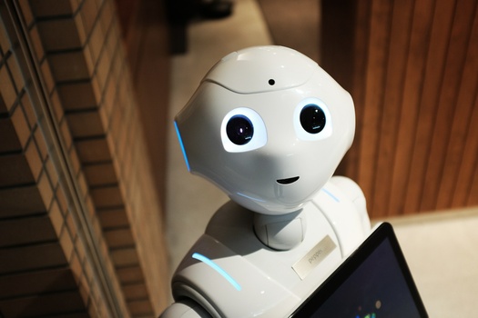 a white AI bot looking up at the camera