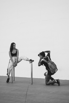 black and white image of a photographer shooting a model