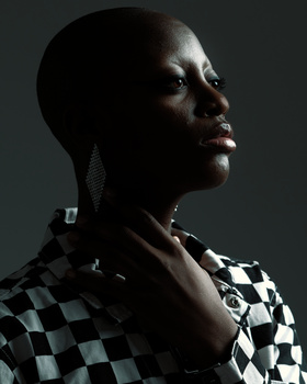 Close up, dark skinned girl, lit from behind