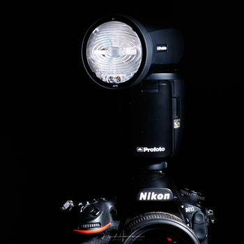 A modern on-camera flash with a swivel head that enables you to direct the light.