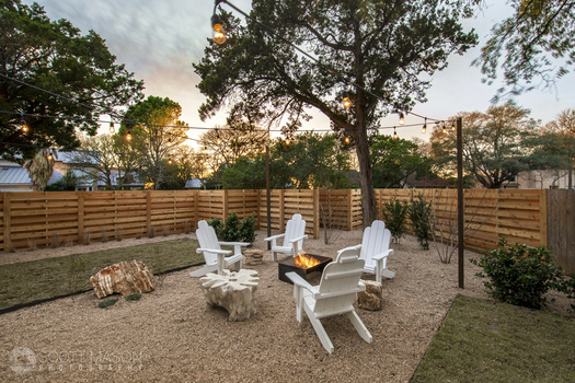 a back patio with a fire burning