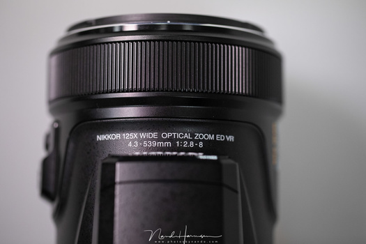 The focal length of this lens is 4.3 mm - 539 mm. With the 1/2.3 inch sensor of the Coolpix P1000 this is equivalent to 24mm - 3000mm on a full frame sensor. It comes to the expense of an aperture that varies between f/2.8 and f/8, among some other thing