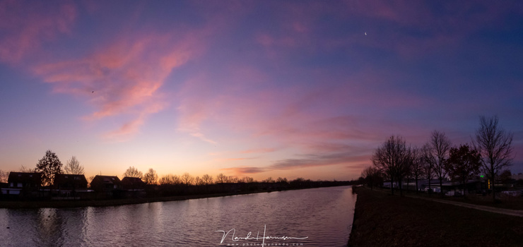 A panorama of three individual shots during twilight. This image size shows not much noise, but zoomed in it will be visible. This one is shot in raw, and processed in Lightroom. (3x 24mm (FF equivalent) - ISO720 - f/8 - 1/125 with -0,7EV)