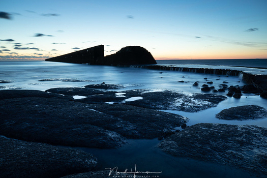 The dynamic range of this landscape is more than the sensor can manage. A neutral density gradient filter could balance the overal brightness of the image.