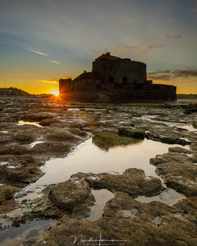 An example how a GND filter can darken the sky, bringing it well within the dynamic range of the sensor, but darkening the fort at the same time, and leaving the reflection of the darkened sky as bright as it would be without a filter.