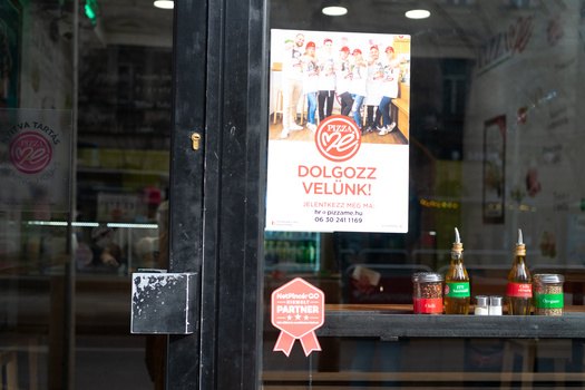 Learning why and how to crop in photography A cafe window with spices and a poster
