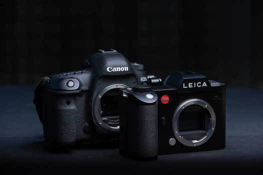 The Canon EOS 5D mark IV DSLR next to the Leica SL mirrorless camera.