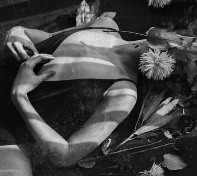 Finding real passion in photography. A model covered with flowers.