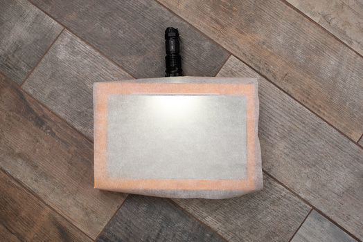 Place the paper Place tracing paper over the cut hole in the box and put the torch through the side