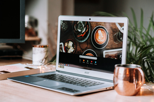 How to maintain work and health balance in photography during COVID-19 Acer laptop with a cup of tea on a desk