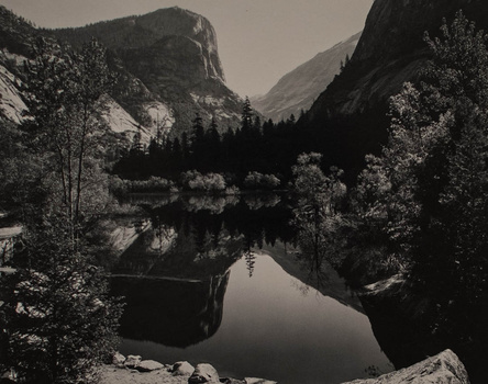 an Ansel Adams image of a mountain scene mirrored in a lake