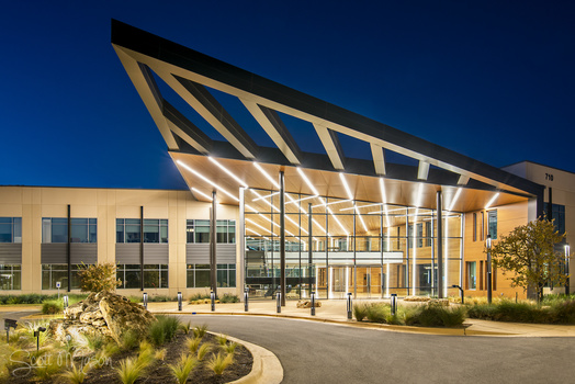 an exterior architectural photo of an office at twilight