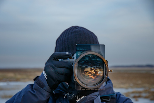 Using exposure bracketing and filters makes it possible to deal with almost every situation. But a good dynamic range is very handy also. If you can have it all, go for it.