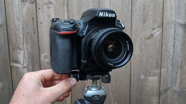 Camera and lens Camera and lens on a tripod