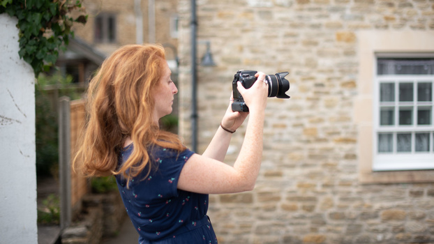 Woman photographing with DSLR Woman photographing with DSLR camera