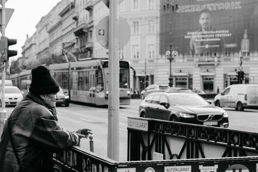 Choosing a theme for your photography project. An older man smoking a cigarette in the street.
