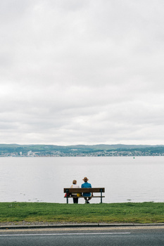 Pursuing personal projects with a purpose and goal in mind. A couple sat on a bench by a lake.