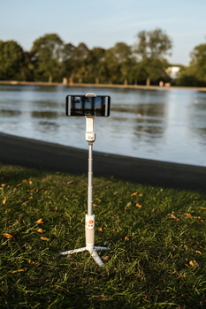 Zhiyun Smooth-XS gimbal extended rod. Zhiyun Smooth-XS gimbal in a park.