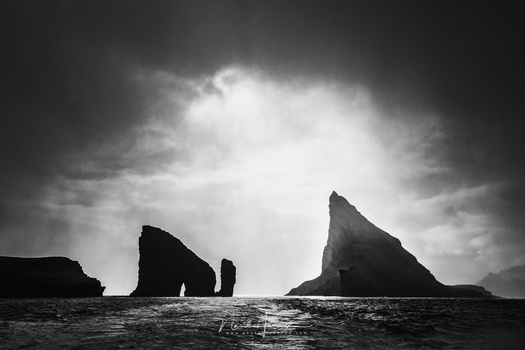 This photo of Drangarnir sea stacks and the islet Tindhólmur at the Faroe islands has a high contrast. In fact, there are many dark and bright tonal values, and almost no midtones. Is this a photo that is right between high key and low key?