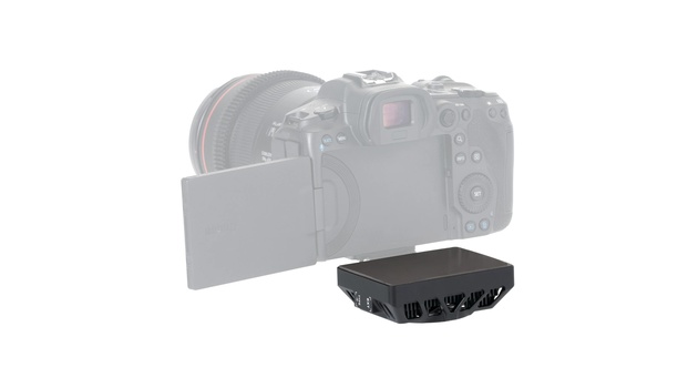 Black camera cooling fan mounted beneath a professional DSLR with attached lens.