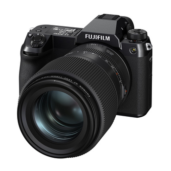 Fujifilm mirrorless camera body with attached telephoto lens on white background.