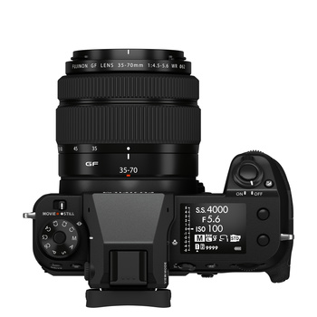 Top-down view of a mirrorless camera with attached zoom lens and external control dial.