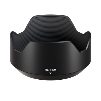 Fujifilm lens hood with flower-shaped design and ribbed interior texture on black background.