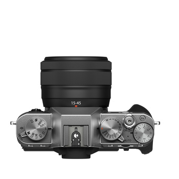 Top-down view of a mirrorless camera body with attached lens showing manual dials and controls.