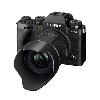 Fujifilm X-T4 mirrorless camera with attached prime lens and lens hood, shown against a white background.