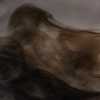 Liquid ink or pigment swirling and dispersing through water in moody, atmospheric tones.