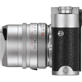 Silver rangefinder camera with attached wide-angle lens shown from a three-quarter view.