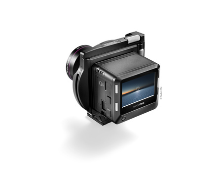 Professional compact video camera with articulating screen and external microphone mounted on top.