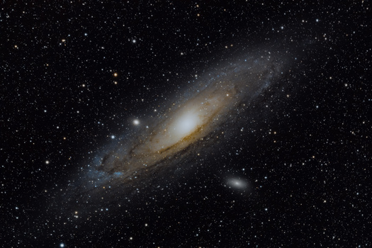 Andromeda Galaxy photographed against a starfield showing its spiral disk structure and central bulge.