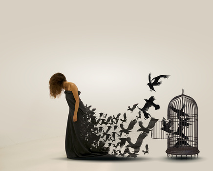 Woman in black dress with silhouettes of birds dispersing from her lower body toward an empty birdcage.
