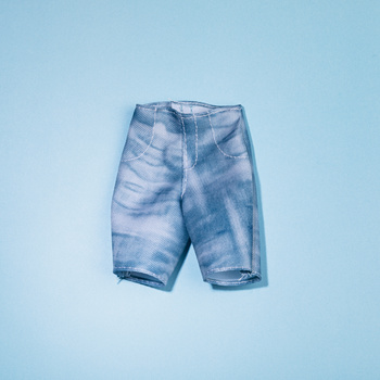 Pair of light blue distressed denim shorts with ripped knees against a solid light blue background.