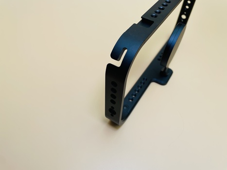 Navy blue silicone watch band with holes and white buckle clasp against light background.