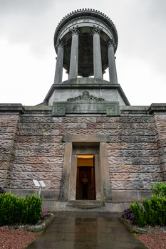 Stone building with tall cylindrical tower featuring a domed roof and vertical ribbed sections.