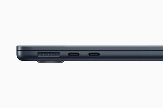 Close-up of a dark gray device's top edge showing speaker grille, USB-C port, and two additional ports.