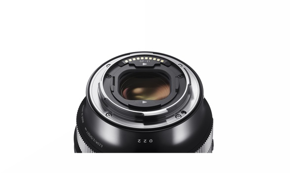 Rear view of a camera lens showing the mount and optical elements with depth of field markings.