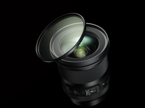 Wide-angle camera lens with front element removed, showing internal glass optics against a black background.