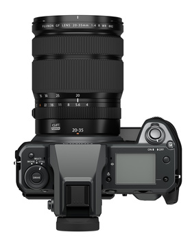 Top-down view of a mirrorless camera with attached telephoto zoom lens and articulating rear screen.